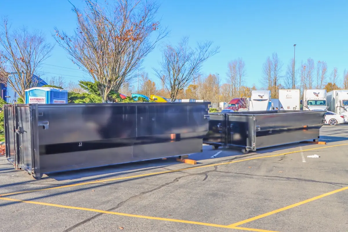 Professional dumpster rental service with roll-off container on residential driveway in Chesapeake